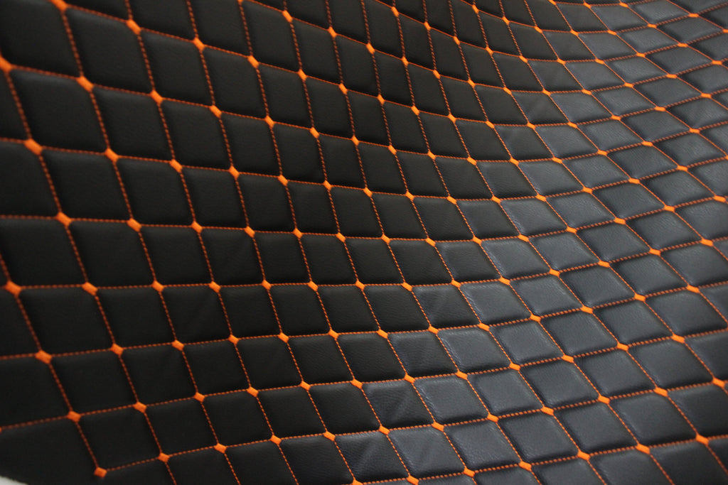 Tecido para estofos automóveis em vinil preto acolchoado laranja com textura granulada | Costura em losango de 5x8cm com espuma | 140cm e 55,1" de largura | Pele sintética (réplica)
